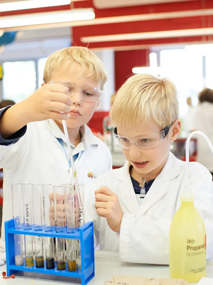 two blond boys at lab bench
